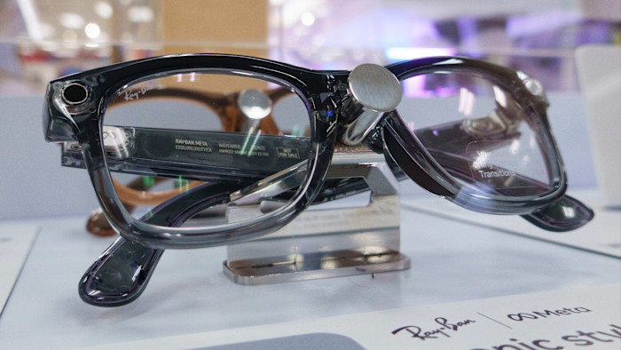 Ray-Ban Meta smart glasses displayed on a stand in a retail store.