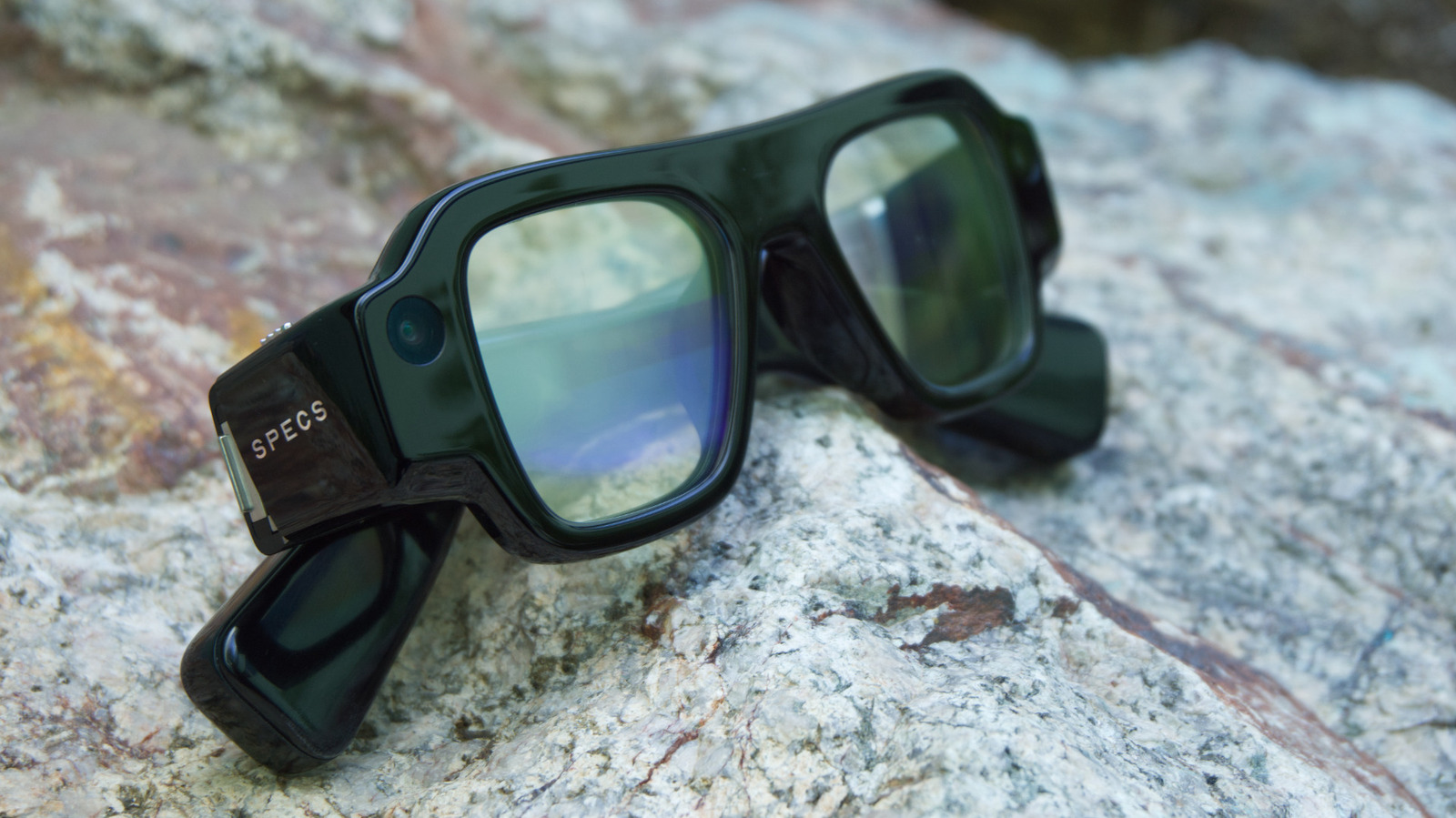Snap's standalone AR Specs glasses shown with a blurred background.